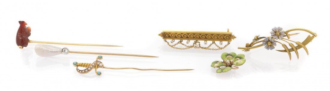 A Collection of Antique Yellow Gold Jewelry, 10.00 dwts: A Collection of Antique Yellow Gold Jewelry, consisting of a sword motif stick pin containing cabochon cut turquoise and seed pearls, a stick pin containing a carved carnelian cow, and a stick pin con