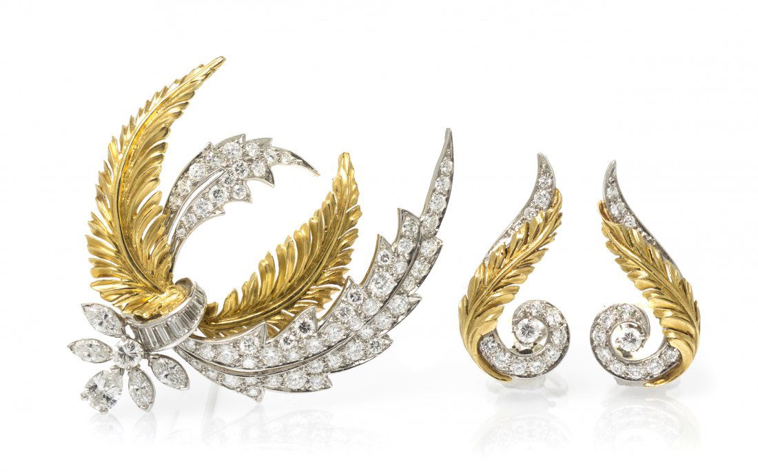 A Vintage Platinum, 18 Karat Yellow Gold and Diamond De: A Vintage Platinum, 18 Karat Yellow Gold and Diamond Demi Parure, McTeigue, in a stylized feather motif, consisting of a platinum and yellow gold brooch containing one round brilliant cut diamond weig