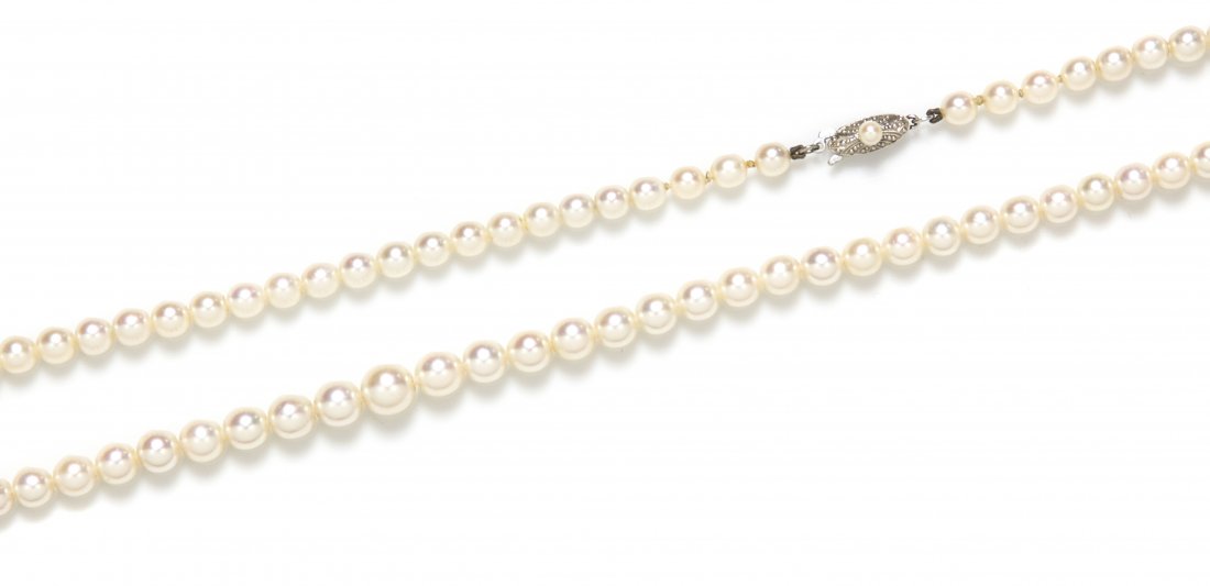 A Single Strand Graduated Cultured Pearl Necklace, Miki: A Single Strand Graduated Cultured Pearl Necklace, Mikimoto, containing 73 pearls measuring approximately 5.13-7.73 mm in diameter strung with a 10 karat white gold clasp containing one pearl measurin