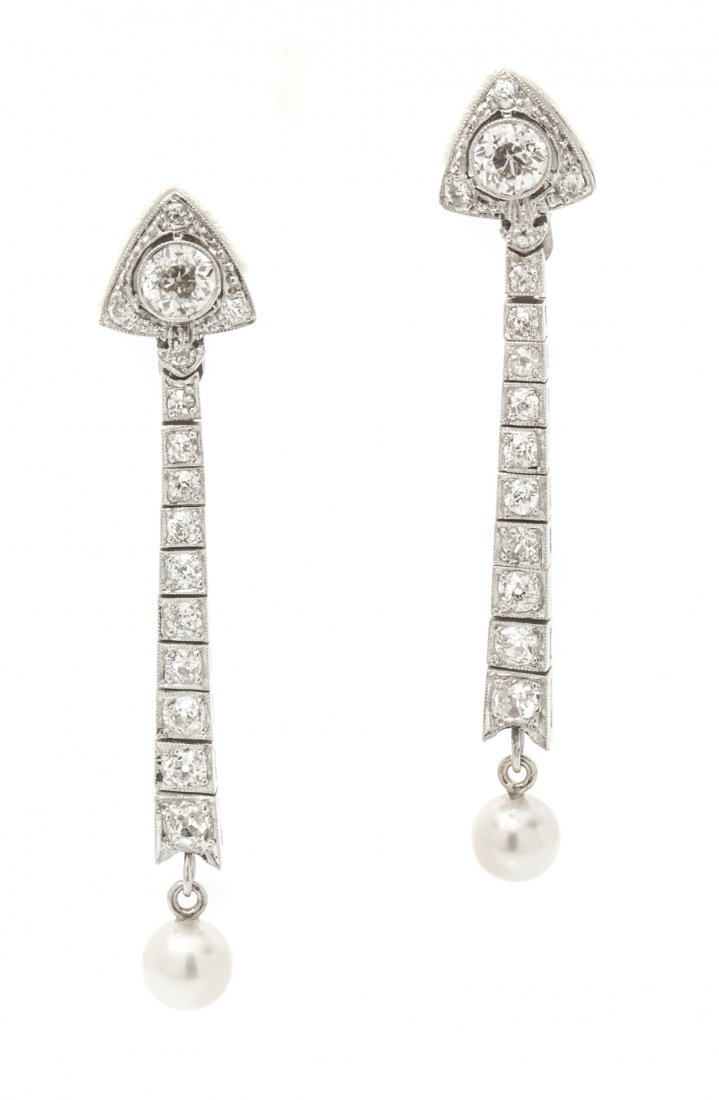 A Pair of Edwardian Platinum, Diamond and Pearl Earclip: A Pair of Edwardian Platinum, Diamond and Pearl Earclips, containing two round pearls (origin not tested) measuring approximately 5.75-5.91 mm in diameter and 30 old European cut diamonds weighing app