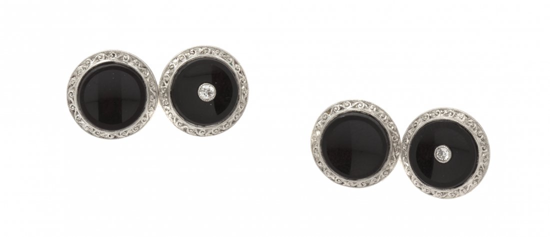 A Pair of Art Deco Gold, Diamond and Onyx Cufflinks, 4.: A Pair of Art Deco Gold, Diamond and Onyx Cufflinks, in a double sided design consisting of four circular onyx plaques, two containing centrally set two round brilliant cut diamonds weighing approxima