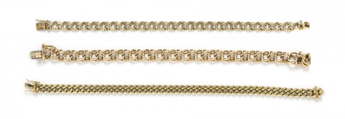 A Collection of 14 Karat Yellow Gold Bracelets, 45.50 d: A Collection of 14 Karat Yellow Gold Bracelets, consisting of two double link bracelets and one squared curb link bracelet. 45.50 dwts. Property from the Estate of Hans E. Dolz M.D., Parker, Colorado