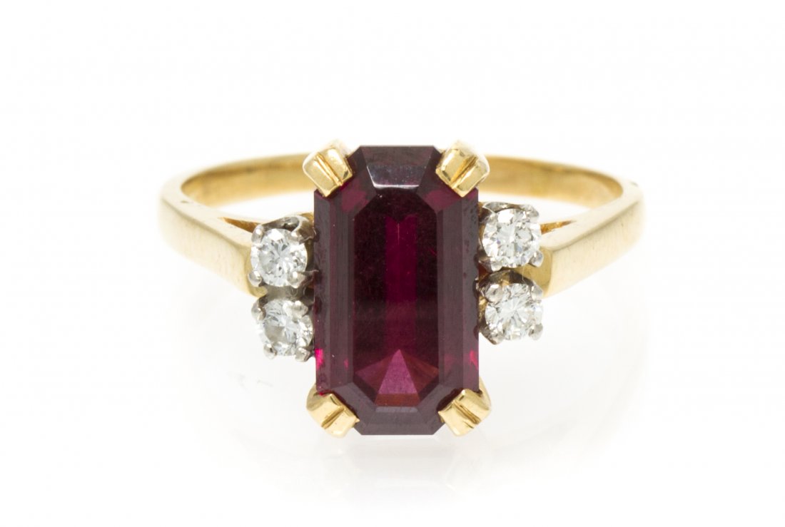 A 14 Karat Yellow Gold, Garnet and Diamond Ring, 3.20 d: A 14 Karat Yellow Gold, Garnet and Diamond Ring, containing one octagonal step cut garnet weighing approximately 3.00 carats and four round brilliant cut diamonds weighing approximately 0.18 carat tot