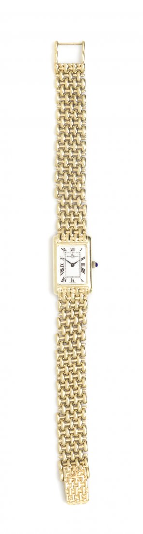 A 14 Karat Yellow Gold Quartz Wristwatch, Baume and Mer: A 14 Karat Yellow Gold Quartz Wristwatch, Baume and Mercier, in a tank style, white dial, Roman numerals, snap on case back, quartz movement, mesh link bracelet, box clasp. 26.15 dwts.