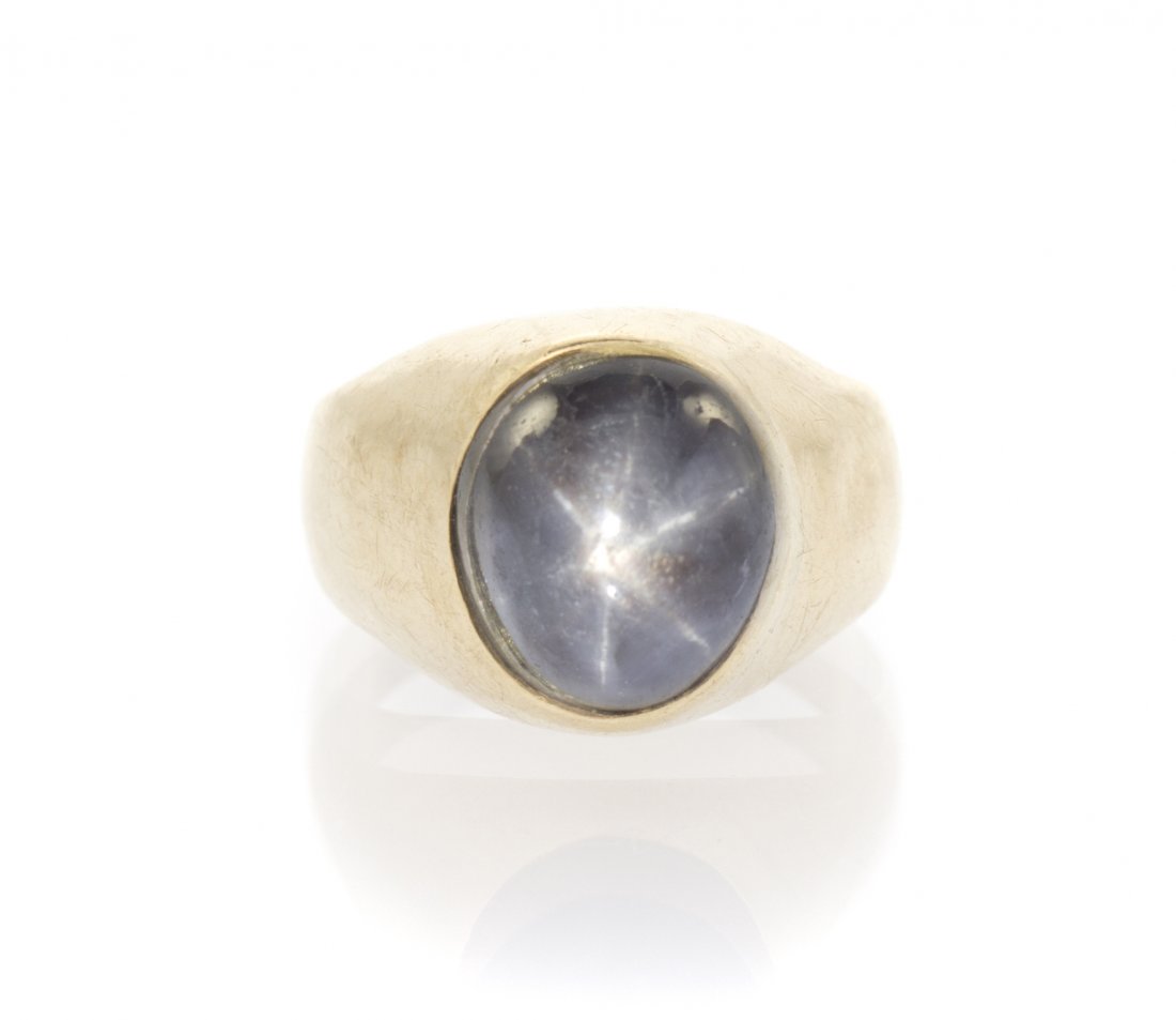 A 14 Karat Yellow Gold and Star Sapphire Ring, 3.60 dwt: A 14 Karat Yellow Gold and Star Sapphire Ring, containing one oval cabochon cut star sapphire weighing approximately 8.48 carats. 3.60 dwts. Property from the Collection of Mr. John Shank, Shorewood, 
