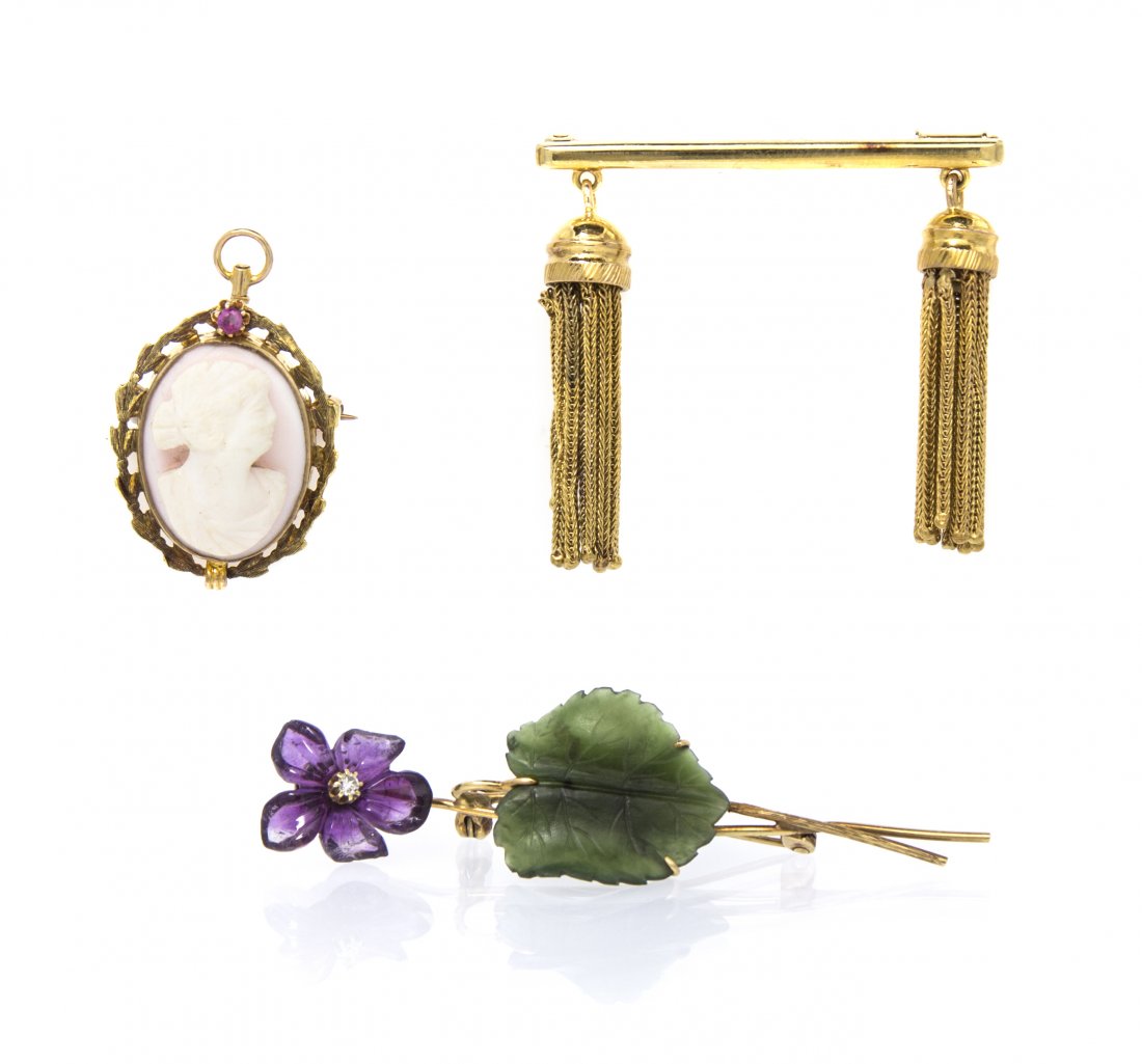 A Collection of 14 Karat Yellow Gold and Multi Gem Broo: A Collection of 14 Karat Yellow Gold and Multi Gem Brooches, consisting of a yellow gold bar brooch with tassel pendant terminals, an oval carved conch shell cameo depicting a Classical female profile