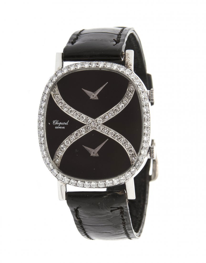 An 18 Karat White Gold and Diamond Dual Timezone Wristw: An 18 Karat White Gold and Diamond Dual Timezone Wristwatch, Chopard, dial and bezel containing 85 round brilliant and single cut diamonds weighing approximately 1.37 carats total, 34.00 x 30.00 mm ca