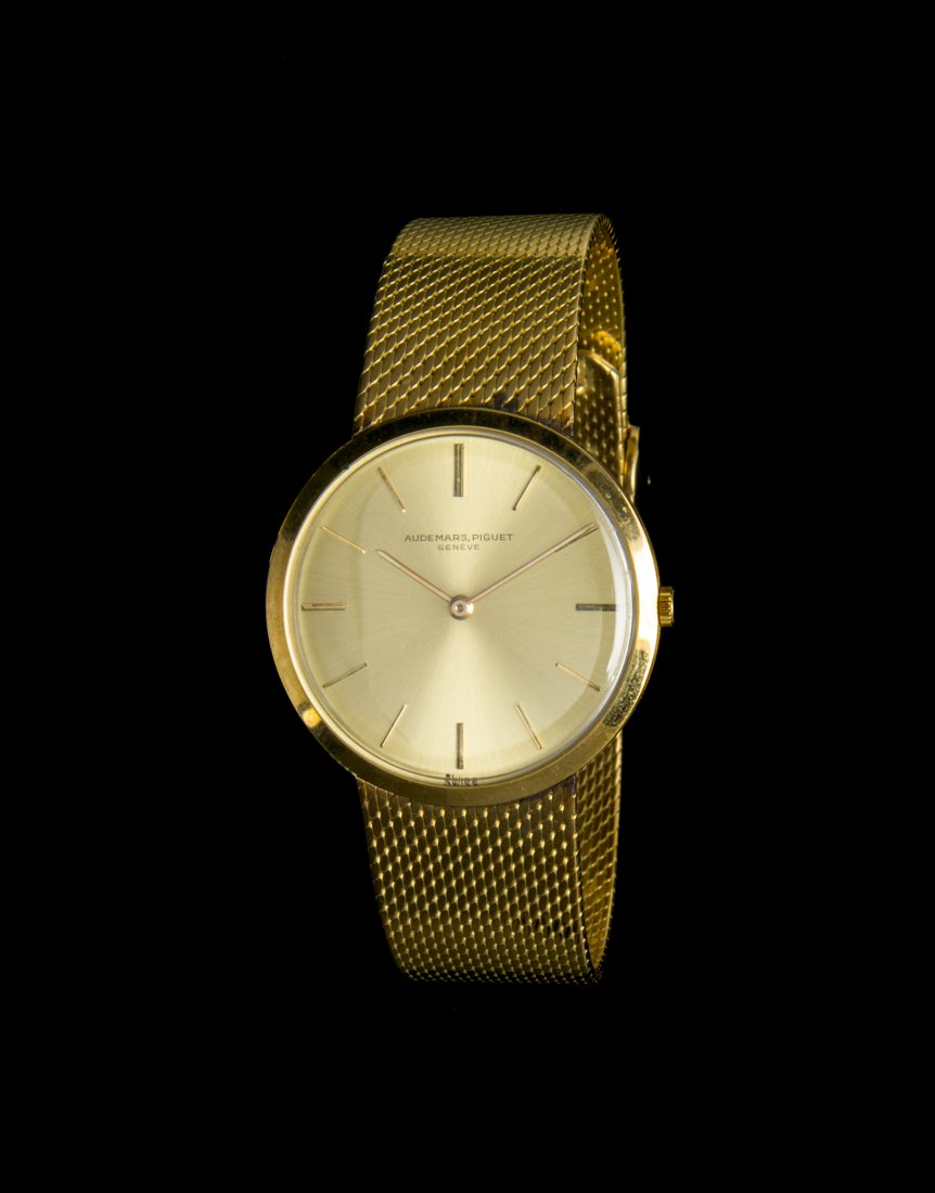 An 18 Karat Gold Wristwatch, Audemars Piguet, Circa 196: An 18 Karat Gold Wristwatch, Audemars Piguet, Circa 1964, 34.00 mm case diameter, brushed gold dial signed Audemars Piguet, applied gold baton numerals, gold baton hands, circular case, coin edge crow