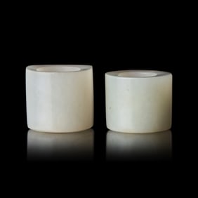 Two Chinese Russet and White Jade Archer's Rings, 18th/19th Century 清中晚期
