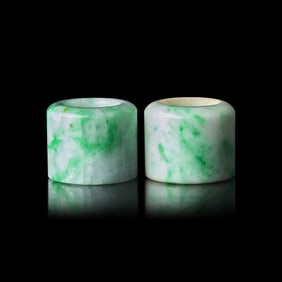 An Associated Pair of Chinese Apple Green and Celadon Jadeite Archer’s Rings, Late