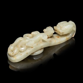 A Chinese Pale Celadon and Russet Jade 'Dragon' Belt Hook, Qing Dynasty 清 青白