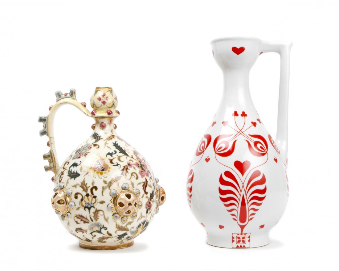 Two Zsolnay Porcelain Pitchers, Height of taller 11 x w: Two Zsolnay Porcelain Pitchers, the first decorated with a painted and gilt floral pattern, the other having red decoration on a white ground. Height of taller 11 x width 5 inches. Property from the E