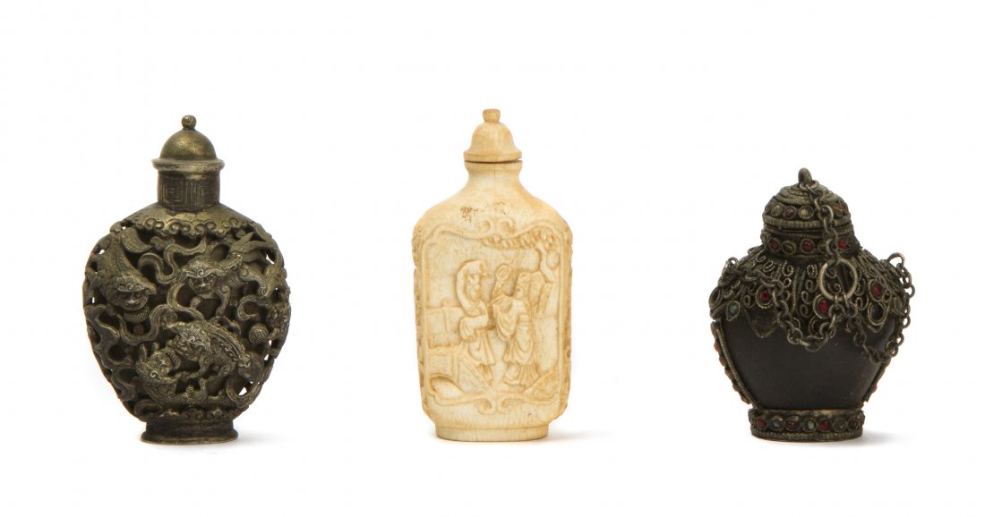 Three Snuff Bottles, Height of tallest 3 1/4 inches.: Three Snuff Bottles, comprising a carved ivory example, a white metal example having fu dog form pierced decoration and a horn and white metal mounted example accented with red paste cabochons. Height