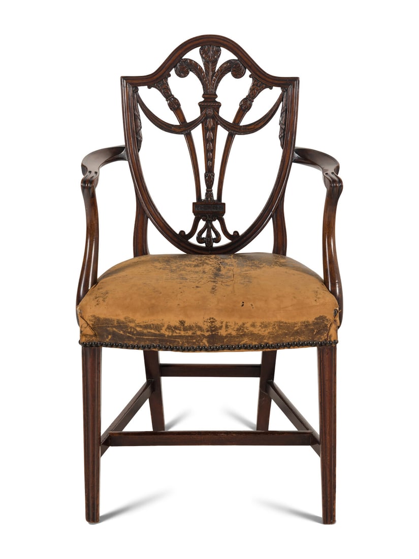 A George III Mahogany Armchair: A George III Mahogany Armchair Circa 1800 decorated in the Hepplewhite taste. Height 38 1/2 x width 23 x depth 23 inches. This lot is located in Chicago.