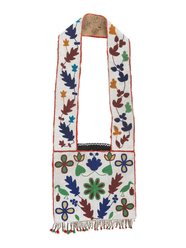 Anishinaabe Beaded Bandolier Bag: Anishinaabe Beaded Bandolier Bag late 19th century having a floral design and beaded loop fringe; flour sack backing length 36 inches x width 13-1/2 inches The Ronny and Do