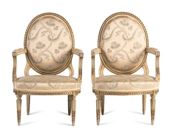 A Pair of Louis XVI Painted and Parcel Gilt Fauteuils