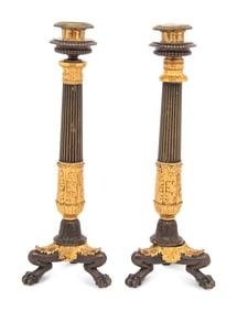 A Pair of French Parcel Gilt and Patinated Bronze Candlesticks