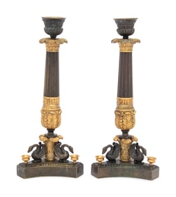 A Pair of French Parcel Gilt and Patinated Bronze Candlesticks