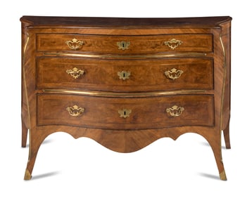 An Italian Gilt Bronze Mounted Serpentine Walnut Commode