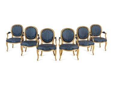 A Set of Six George III Carved Giltwood Armchairs