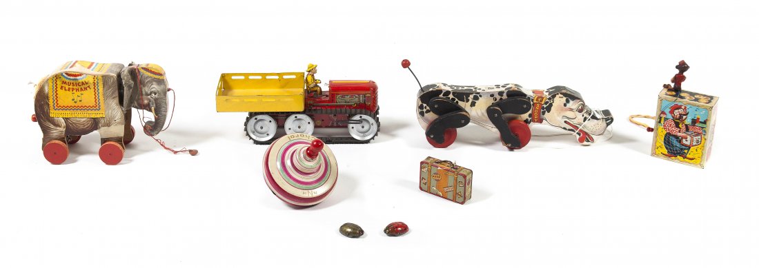 A Collection of Vintage Toys, Height of tallest 7 1/2 i: A Collection of Vintage Toys, comprising a musical elephant pull toy, a German tin top, a tin bank in the form of a suitcase, a Fisher Price Snoopy pull toy, a Mattel music maker toy, two Animate wind