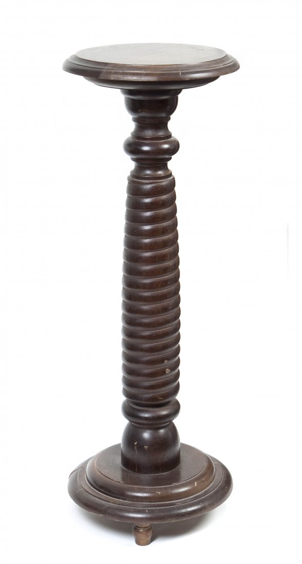 A Mahogany Pedestal, Height 36 inches.: A Mahogany Pedestal, having a circular top raised on a spiral turned support above a circular base, ending in modified turnip feet. Height 36 inches. Property from the Collection of Marshall and Natal