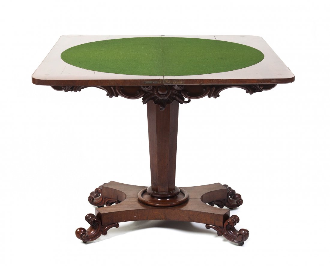 A French Mahogany Games Table, Height 29 1/2 x width 36: A French Mahogany Games Table, the rectangular flip-top with rounded corners opening to a felt lined interior over the tapering hexagonal standard, ending in a quadripartite base with scrolling feet, 