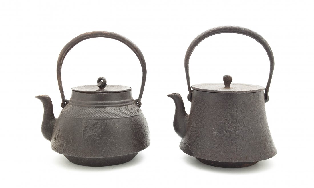 Two Japanese Cast Iron Hot Water Kettles, Diameter of l: Two Japanese Cast Iron Hot Water Kettles, one having a band of raised bosses to the shoulder and scrolled foliate decoration. Diameter of largest 7 inches.