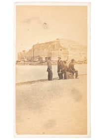 CDV featuring men sitting atop a large format camera on the sand bar in front of Ft. Sumter by John