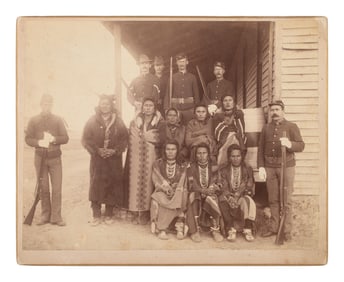 [CROW UPRISING]. Photograph of a group of Crow prisoners under guard at Crow Agency, Montana, 1887.