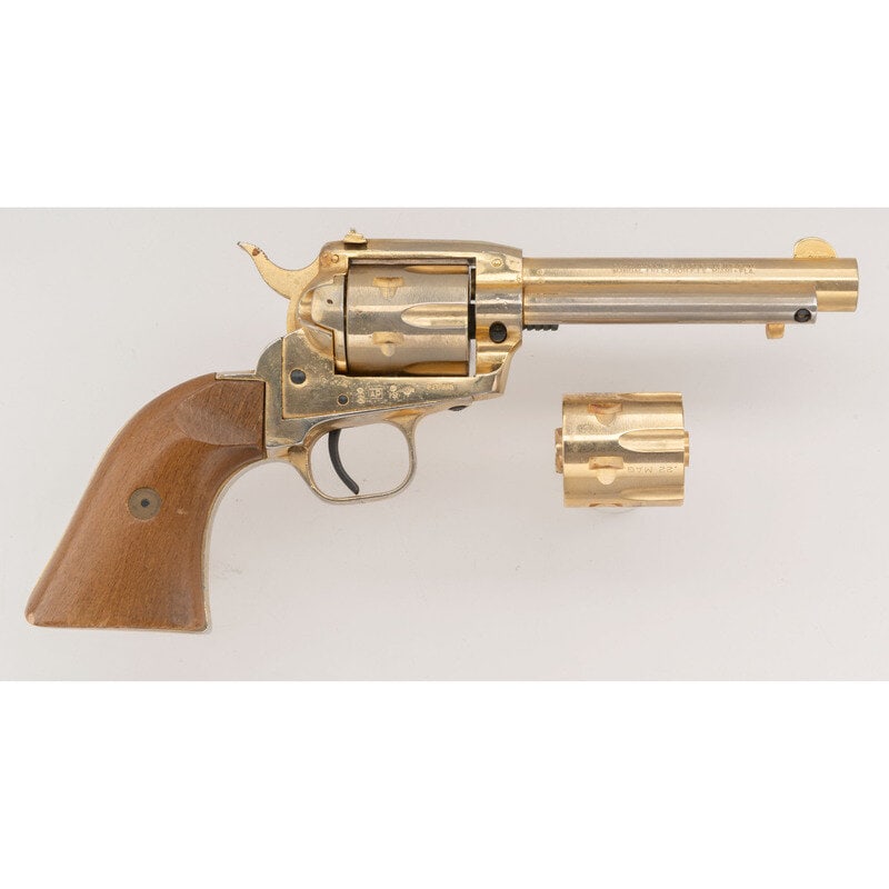 *FIE Model E-15 22LR: *FIE Model E-15 22LR .22lr. 4.75" barrel length. SN: TC34535. Gold plated metal finish overall with wood grip panels mounting rear peep sight and bladed front sight and hammer block safety. Single act