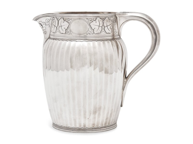 A Tiffany & Co. Sterling Silver Water Pitcher: A Tiffany & Co. Sterling Silver Water Pitcher New York, Mark for 1907-1947, Directorship of John C. Moore The neck with grapevine patterned frieze over a faceted tapering body, marked 'TIFFANY &am