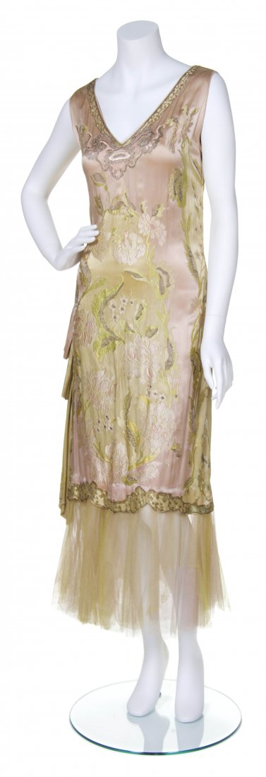 A Pink and Green Silk Embroidered Dress,: A Pink and Green Silk Embroidered Dress, circa 1923, attributed to Callot Soeurs, pink silk ground with allover foliate embroidery, pink and green tulle trim around bottom. No label. Property from a M