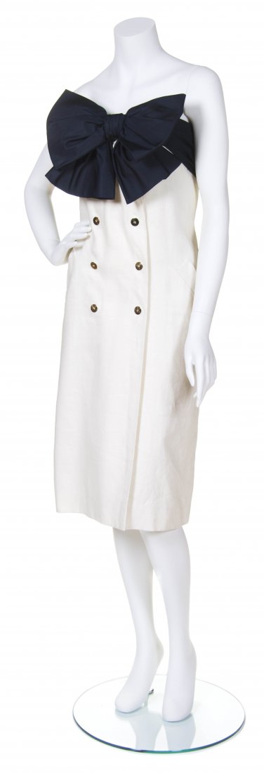 A Bill Blass White Linen Dress, Size 10.: A Bill Blass White Linen Dress, double breasted with goldtone buttons, navy cotton panel around top with large bow at front. Labeled: Bill Blass / Neiman Marcus. Size 10. Property from the Estate of F