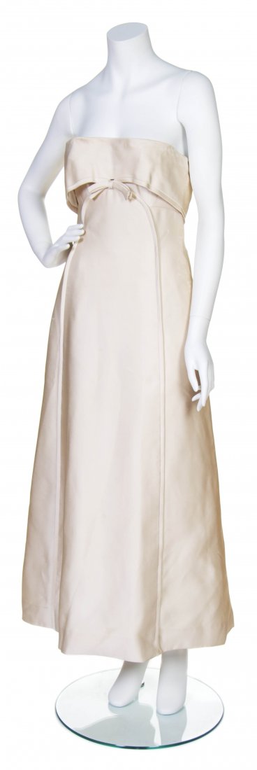 A Pierre Balmain Couture Vintage Champagne Strapless Dr: A Pierre Balmain Couture Vintage Champagne Strapless Dress, with bow detail to front and covered buttons at back. Labeled: Pierre Balmain Paris / tape label illegible / Ensemble Shop.