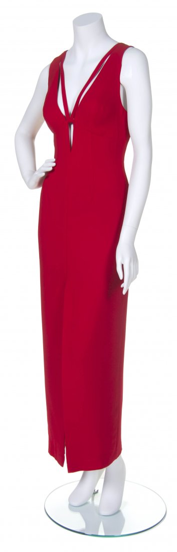 A Valentino Red Evening Gown,: A Valentino Red Evening Gown, plunging neckline, criss cross straps in the back, front center slit. Labeled: Valentino Boutique.