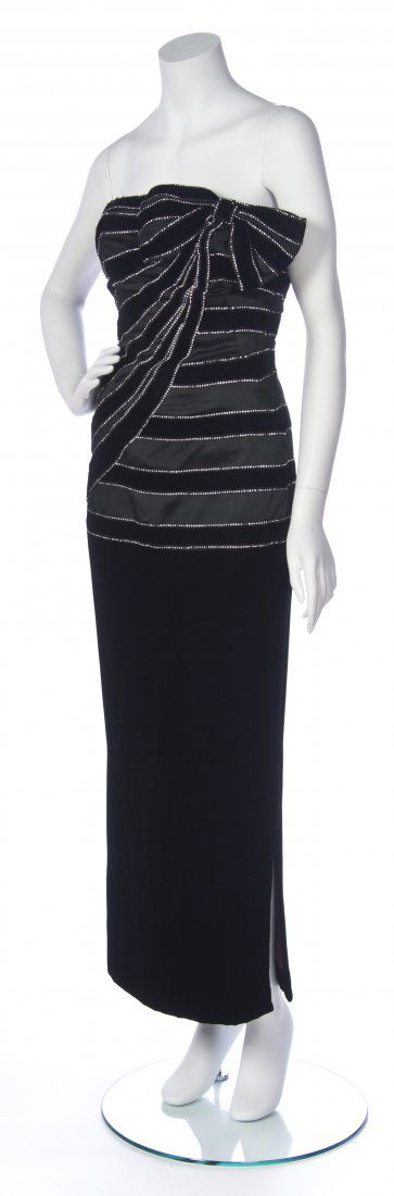 A Murray Arbeid Black Velvet and Rhinestone Strapless E: A Murray Arbeid Black Velvet and Rhinestone Strapless Evening Gown, rhinestone trimmed strips of velvet wrapping around the bodice, bow detail to neckline. Labeled: Murray Arbeid London/ Neiman Marcus