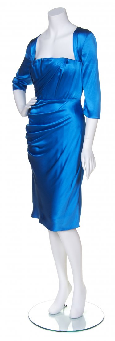 A Douglas Hannant Blue Satin Cocktail Dress,: A Douglas Hannant Blue Satin Cocktail Dress, square neckline, elbow length sleeves, with draping to bodice and ruched side. Labeled: Douglas Hannant. Property from the Collection of Patricia Raynes