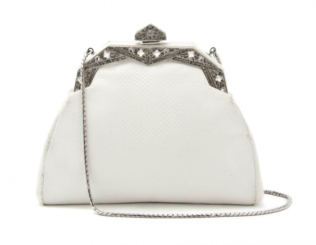 A Judith Leiber White Snakeskin and Rhinestone Evening : A Judith Leiber White Snakeskin and Rhinestone Evening Bag, silver chain strap, rhinestone Art Deco style top frame, cream silk lining, with mirror and comb. Stamped: Judith Leiber. 6 1/2 x 5 1/2 x 1