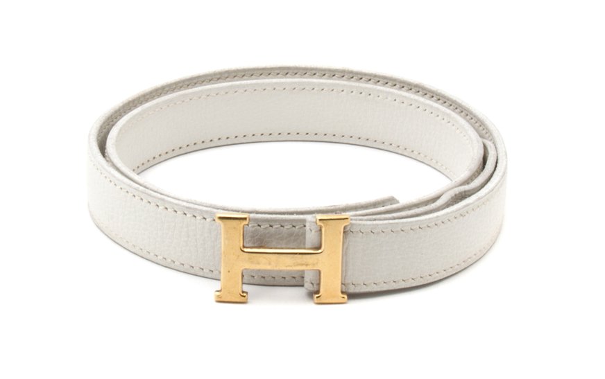 An Hermes White Leather Mini Constance Belt,: An Hermes White Leather Mini Constance Belt, with gold H buckle, blindstamp circle E. Stamped: Hermes. Property from the Collection of Nathalie Bardo Holtzman, Los Angeles, California