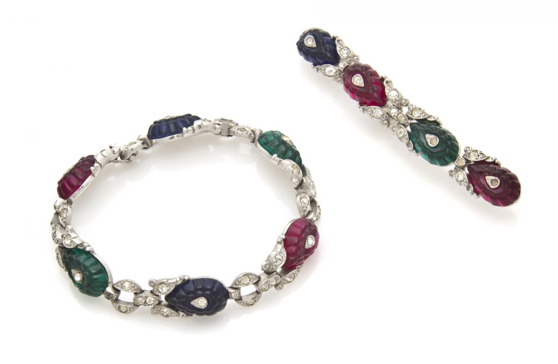 A Trifari Fruit Salad Set,: A Trifari Fruit Salad Set, 1940s, comprised of a bracelet and bar brooch each with alternating carved blue, green and red leaves punctuated by rhinestone links. Stamped: Trifari (partially obscured).