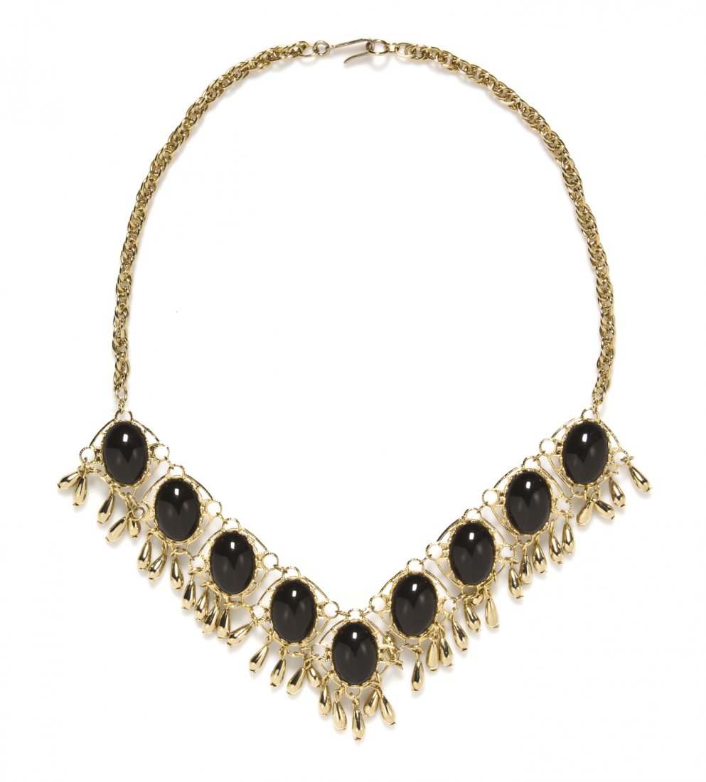 A Trifari Double Sided Black and White Necklace,: A Trifari Double Sided Black and White Necklace, with goldtone panels each having a black oval resin cabochon on one side and a white oval resin cabochon on the other. Stamped: Trifari.