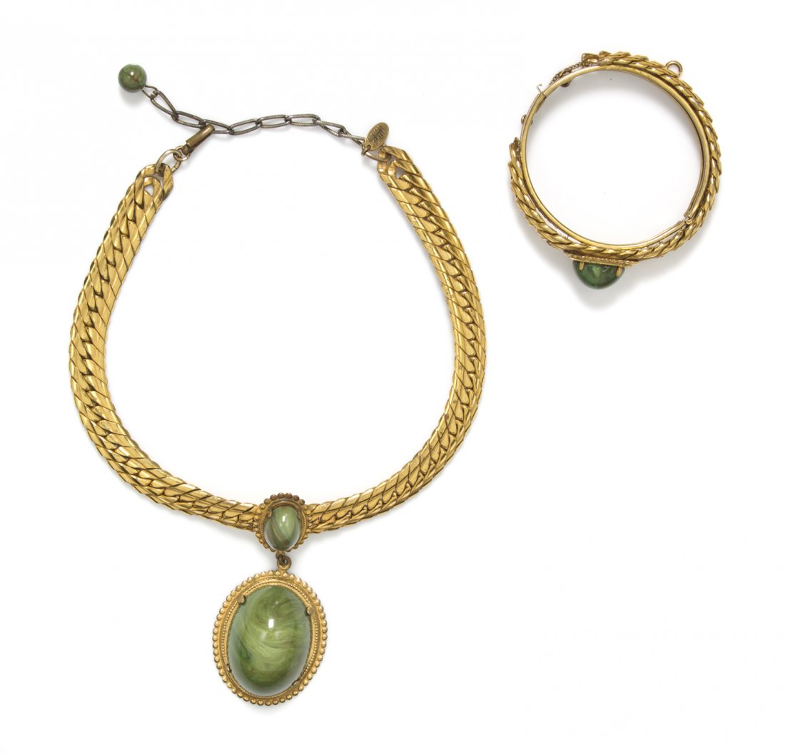 A Miriam Haskell Set,: A Miriam Haskell Set, comprised of a necklace with a large green oval cabochon pendant suspended from a goldtone chain and a matching bracelet. Both stamped: Miriam Haskell.