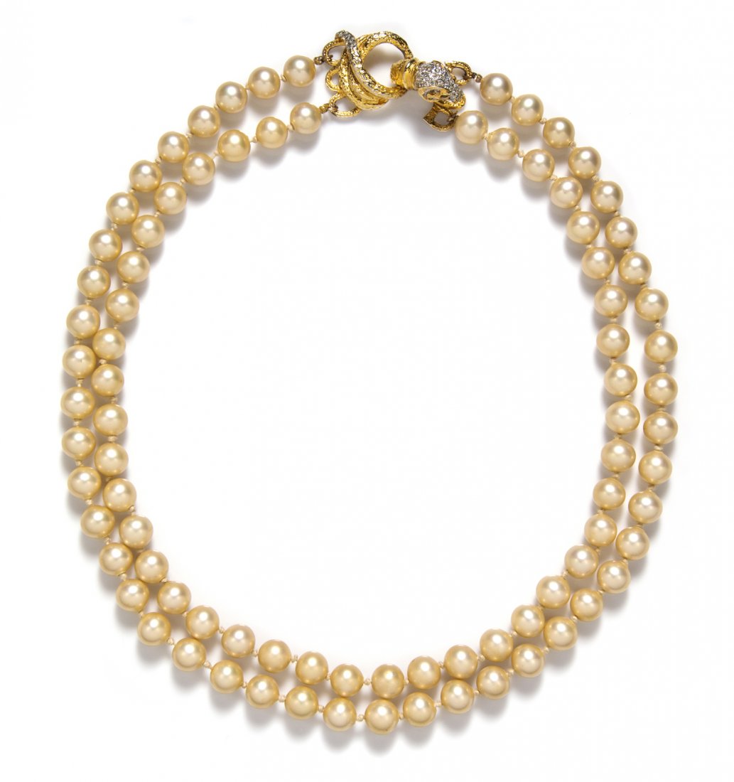 A Kenneth Jay Lane Gold Faux Pearl Necklace,: A Kenneth Jay Lane Gold Faux Pearl Necklace, with rhinestone ram head clasp. Stamped: KJL Laguna. Property from an Important Collector, Chicago, Illinois