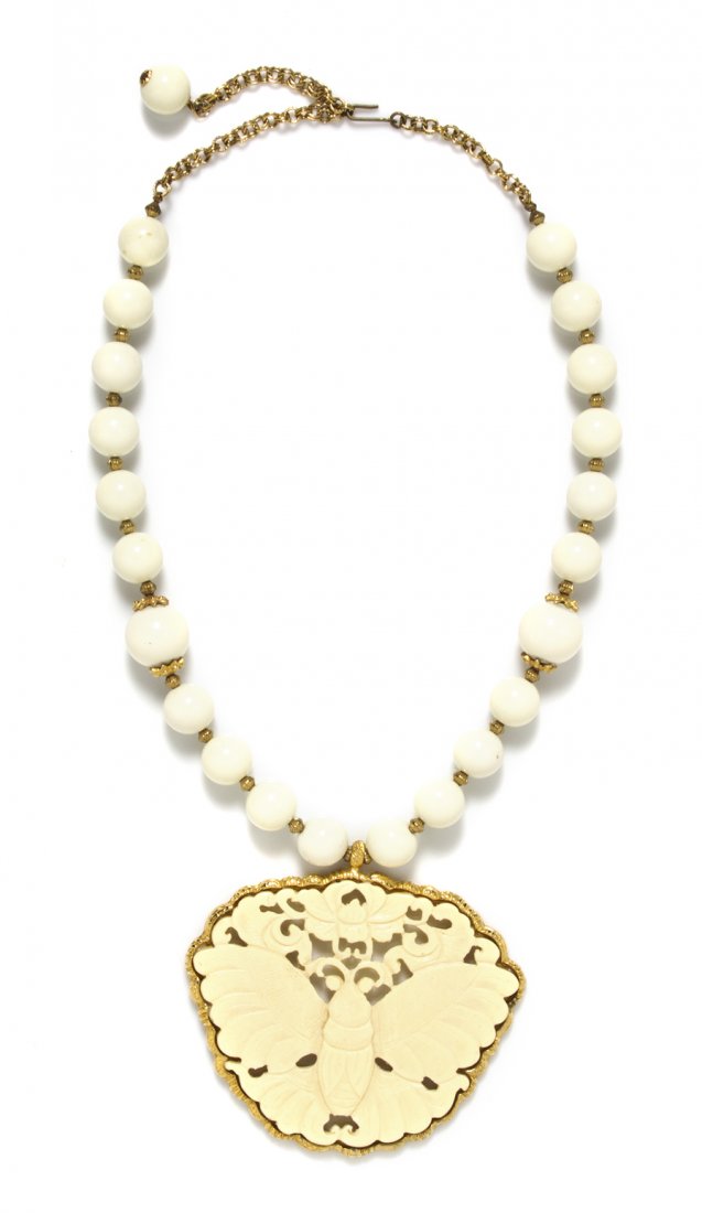 A Kenneth Jay Lane Cream Resin Butterfly Pendant Neckla: A Kenneth Jay Lane Cream Resin Butterfly Pendant Necklace, cream resin butterfly pendant suspended from a strand of cream beads. Stamped: Kenneth Lane. Property from an Important Collector, Chicago, I