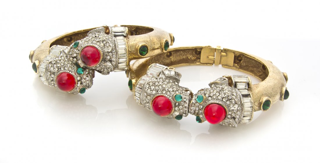 A Pair of Kenneth Jay Lane Foo Dog Hinged Bangle Bracel: A Pair of Kenneth Jay Lane Foo Dog Hinged Bangle Bracelets, comprised of a matching pair of bangles one in a bypass style and the other with meeting terminals, both with rhinestone foo dog head termin
