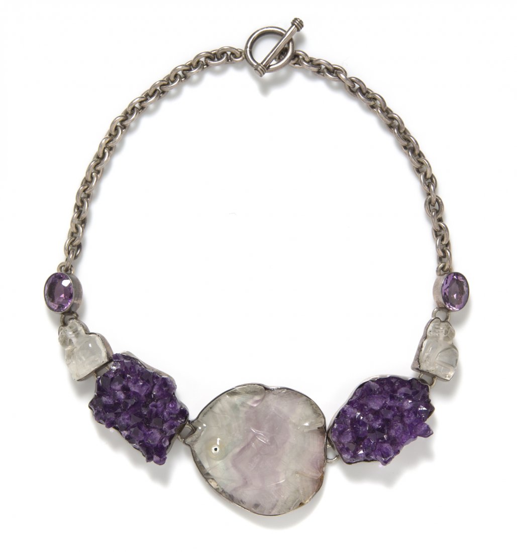 An Amy Kahn Russell Sterling Silver and Amethyst Neckla: An Amy Kahn Russell Sterling Silver and Amethyst Necklace, with large green and purple amethyst carved fish pendant flanked by rough amethyst geodes suspended from a sterling silver chain. Stamped: St