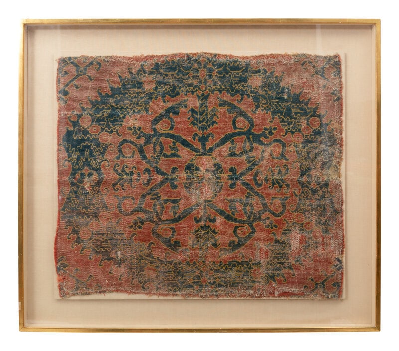 A Fragment of a Spanish Alcaraz Rug: A Fragment of a Spanish Alcaraz Rug Early 16th Century wool; mounted and glazed in a gilt frame. Fragment, 23 x 28 inches. This lot is located in Palm Beach.