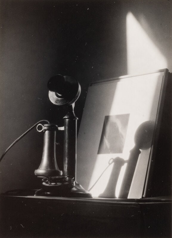 Dorothy Norman (American, 1905-1997) Telephone, in front of Alfred Stieglitz "Equivalent," at An Ame: Dorothy Norman (American, 1905-1997) Telephone, in front of Alfred Stieglitz "Equivalent," at An American Place, New York, ca. 1940; printed later gelatin silver print signed in ink and with stamp bea