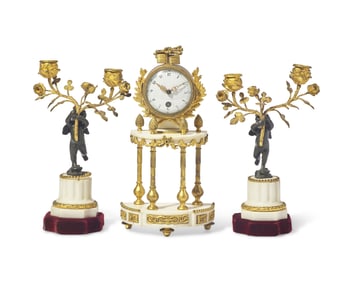 A Louis XVI Style Gilt and Patinated Bronze Mounted White Marble Three-Piece Clock Garniture